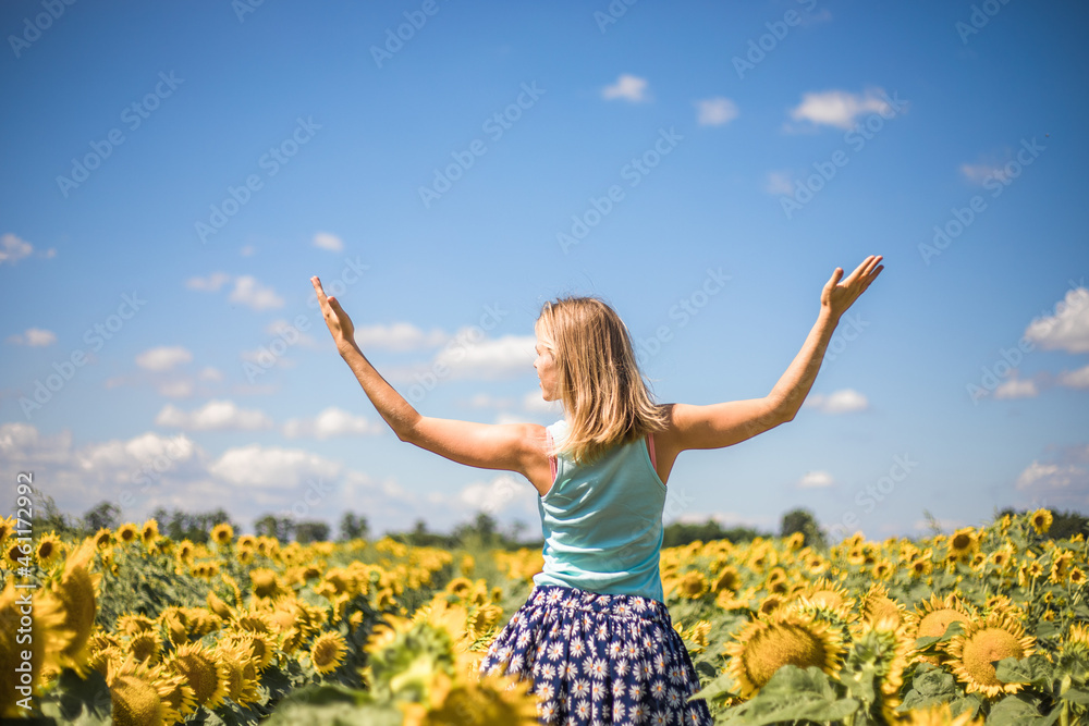 Beauty sunlit woman on yellow sunflower field Freedom and happiness concept. Happy girl outdoors Beauty sunlit woman on yellow sunflower field Freedom and happiness concept. Happy girl outdoors