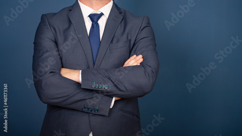 Businessman in suit standing with crossed arms
