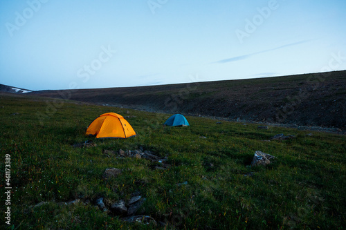 Tent camp in the autumn taiga in Siberia. Tourists have set up camp in the field. Travel  active lifestyle  freedom in nature.