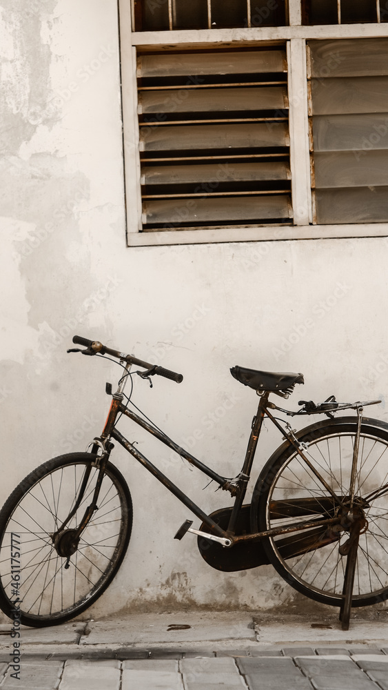 old bicycle in front of a wall
