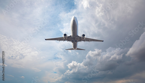 White passenger airplane over the  clouds  - Travel by air transport