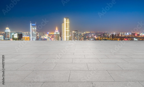 empty brick floor with city skyline background
