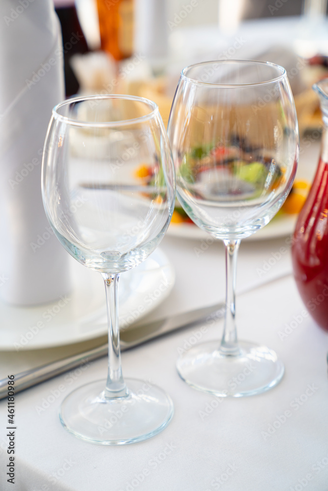 two empty wine glasses on the dining table. two empty wine glasses on the dining table.