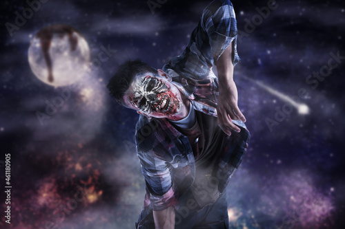 Scary zombie man walking at Halloween night