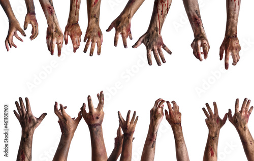 Many hands of scary zombies on white background
