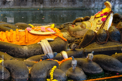 Photos Kathmandu, Nepal - October 2021: Reclining statue of Vishnu as Narayan, the creator of all life in Budhanilkantha on October 5, 2021 in Kathmandu, Nepal