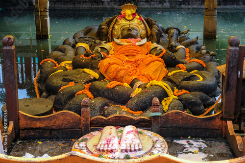 Kathmandu, Nepal - October 2021: Reclining statue of Vishnu as Narayan, the creator of all life in Budhanilkantha on October 5, 2021 in Kathmandu, Nepal. photo