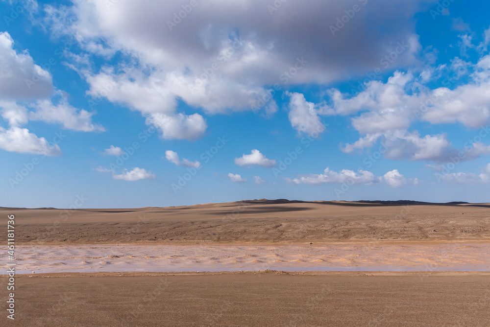 Nature and landscapes of seasonal river and valleys in dasht e lut or sahara desert with cloudy sky Nature and landscapes of seasonal river and valleys in dasht e lut or sahara desert with cloudy sky