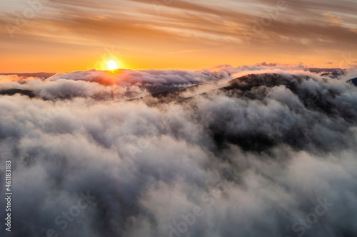 Aerial view of foggy sunrise in the mountains. Carpathian mountains.