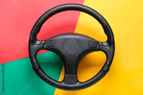 Modern steering wheel on  color background © Pixel-Shot