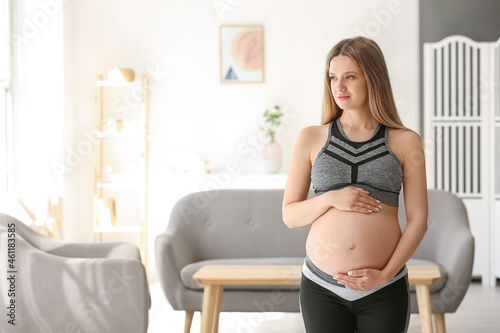 Young pregnant woman practicing yoga indoors Free Download Young pregnant woman practicing yoga indoors - GFXLoad