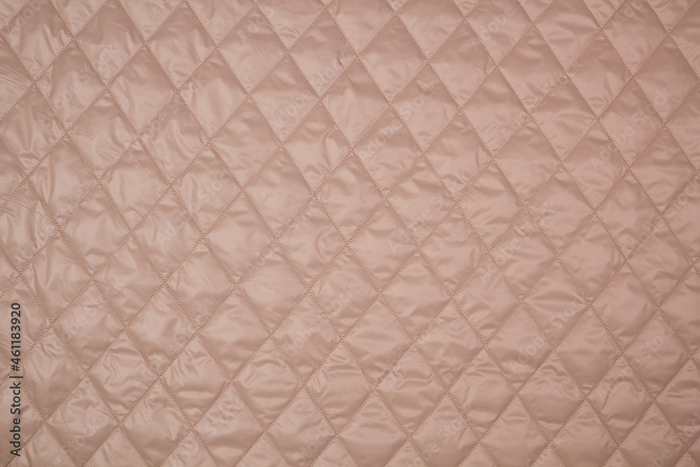 Fototapeta premium Quilted fabric. The texture of the blanket. Beige textiles 