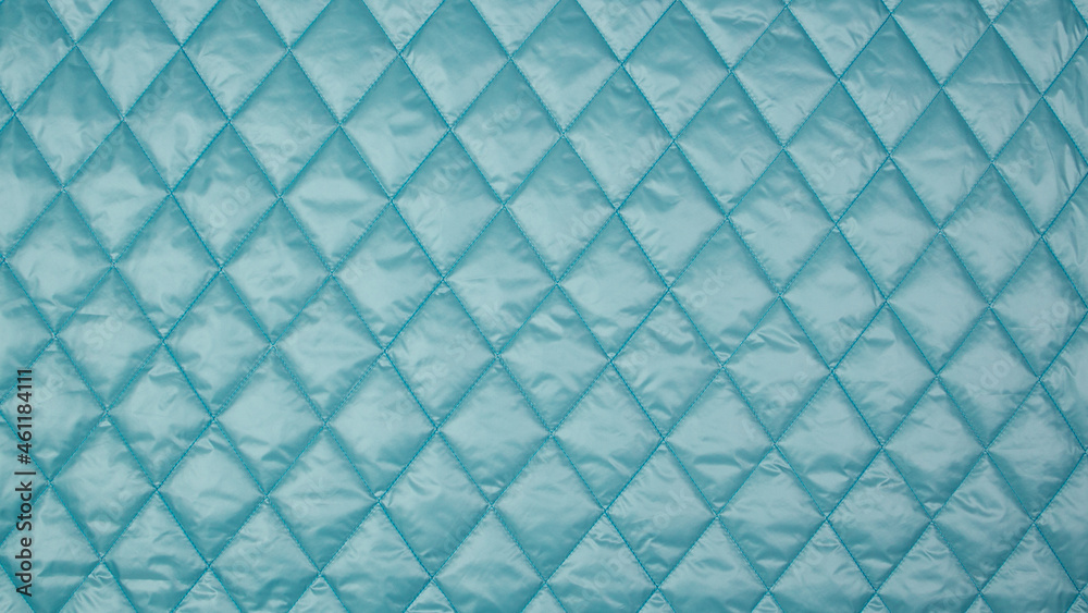 Quilted fabric. The texture of the blanket. Blue textiles
Quilted fabric. The texture of the blanket. Blue textiles