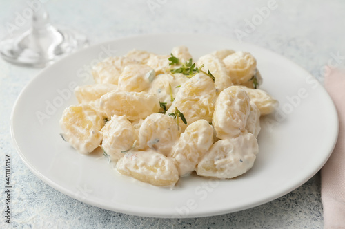 Plate of delicious gnocchi with creamy sauce on white background, closeup