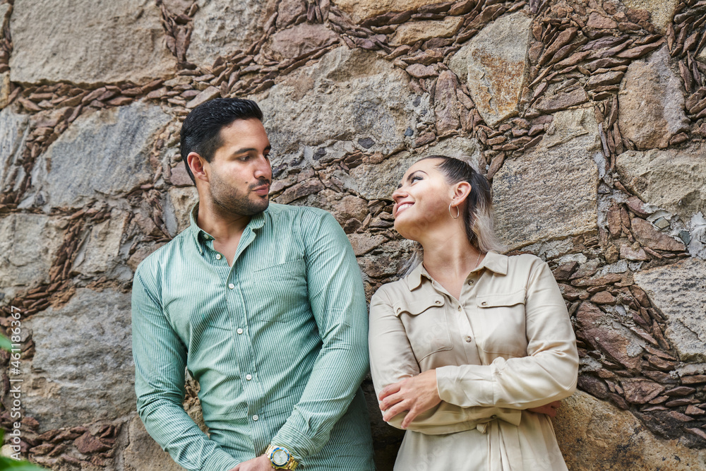 Young latin male and female couple looking at each other in love between 25 and 35 years old