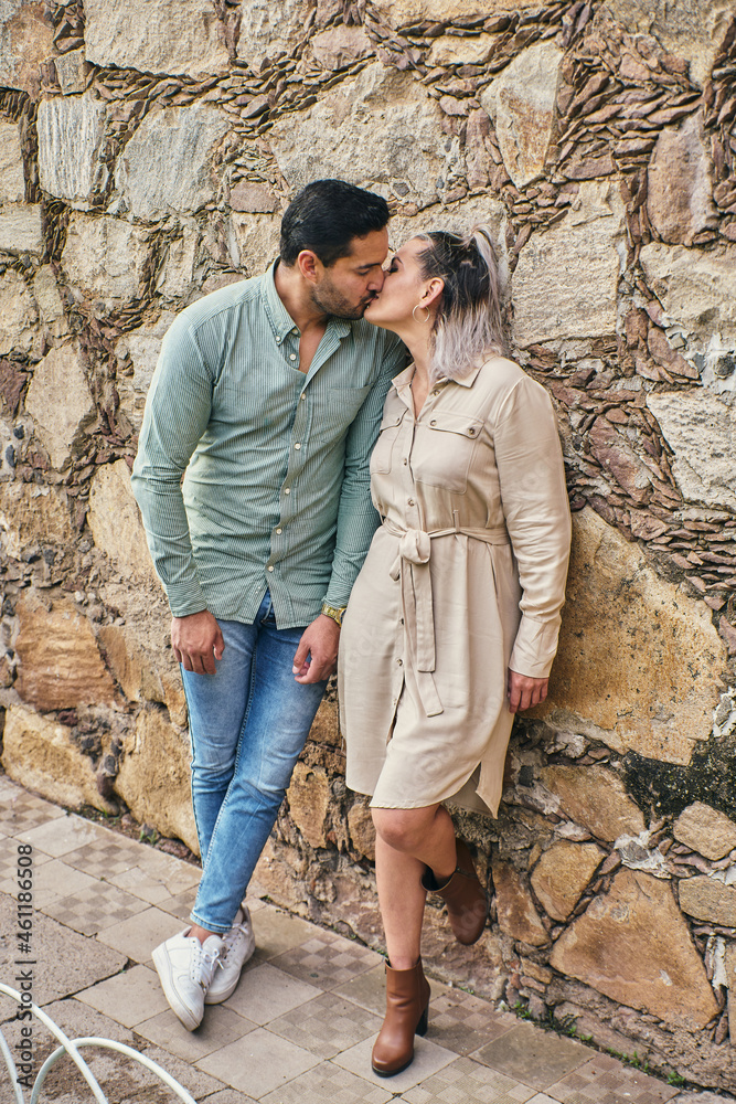 Young latin male and female couple in love kissing between 25 and 35 years old