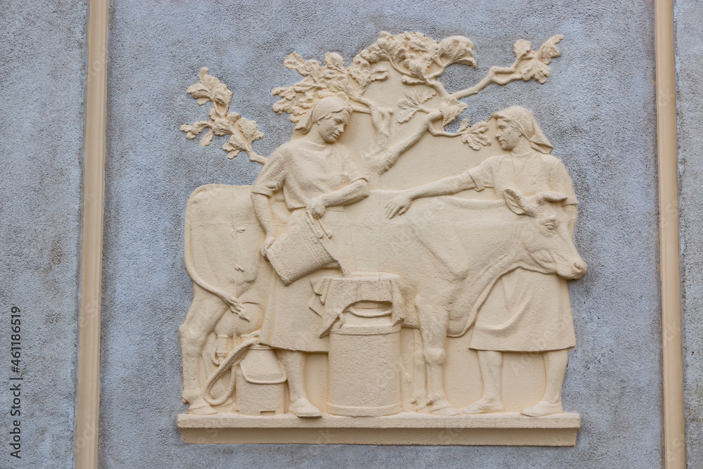 Themed sculptural murals decorating the walls of buildings. Bas-relief on the wall.