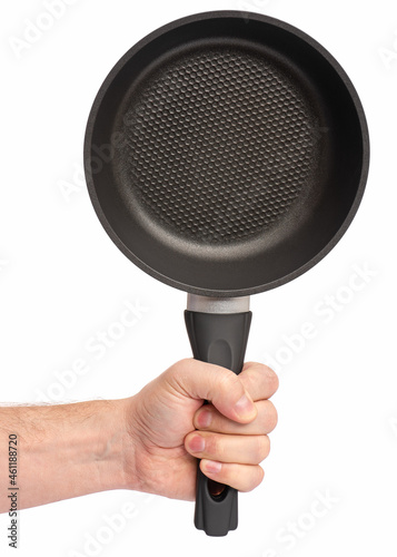Male hand holding simple new empty Non-stick Frying Pan with black handle, isolated on white background.