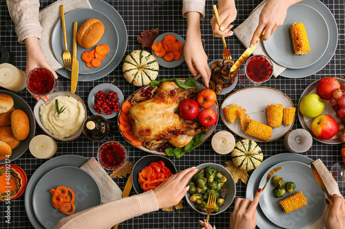 People eating different delicious food at festive Thanksgiving table