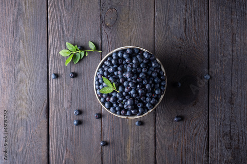 Blueberry bowl on wooden background with copy space in rustic style