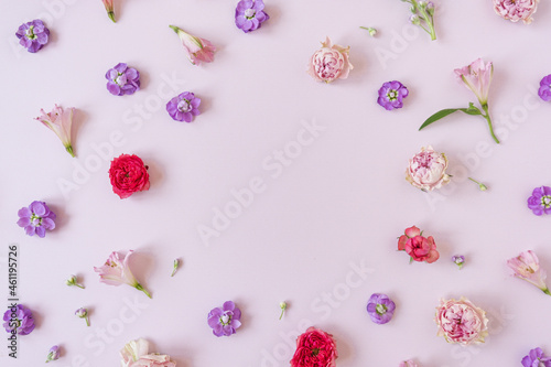 Abstract floral aesthetic background. Floral frame wreath of colourful rose flowers on pink background with blank copy space mockup. Beautiful flowers and petals template