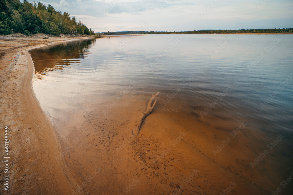 Riverbank landscape with orange sand