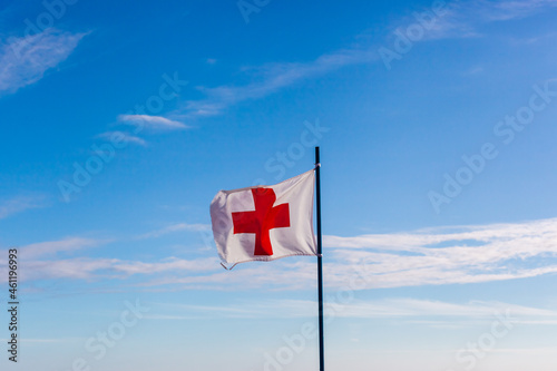 white flag with red cross