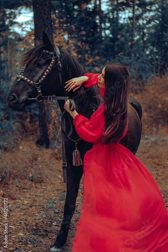 A girl strokes a horse, a girl looks at a horse straight, love for an animal, a girl in the autumn forest with a horse, a photo shoot in autumn with a horse, a walk with a horse, a walk in the autumn 