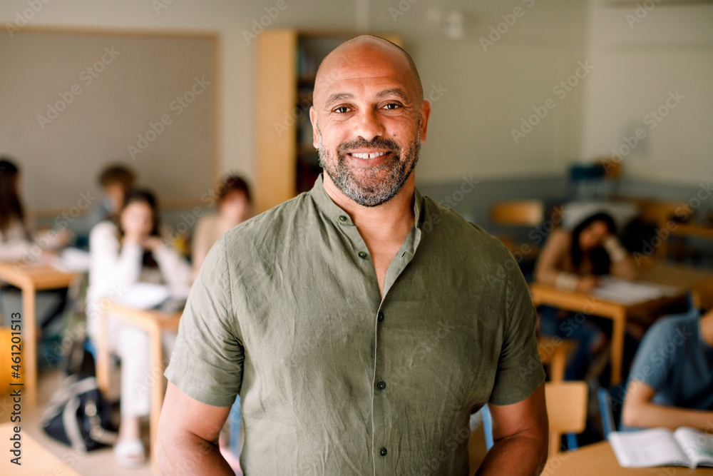 Portrait of smiling male professor in classroom Portrait of smiling male professor in classroom