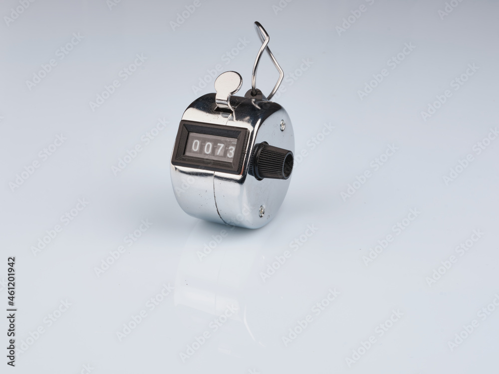 Obraz premium Hand counter clicker on white background. seventy-three