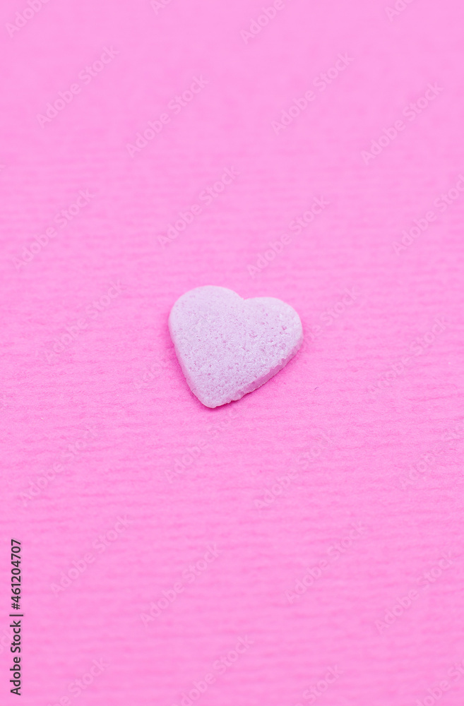 Fototapeta premium Pink heart on pink background. Saint Valentine's day concept. Love and romantic photo. Postcard for holiday. Beautiful warm wallpaper with love. Soft focus. Copy space.