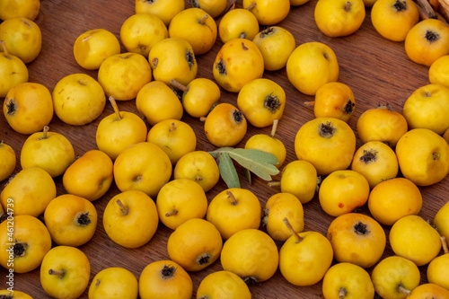 Close up of fresh ripe yellow hawthorn fruits, forest fruits.