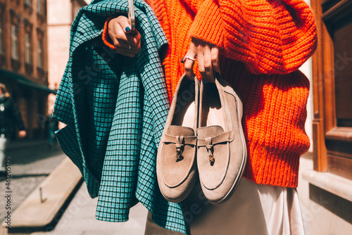 Canvastavla Close-up photo of fashionable women in orange sweater and beige dress holding in