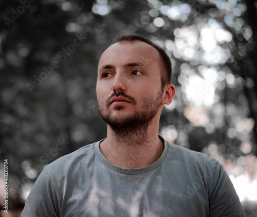 A guy with a beard looks away