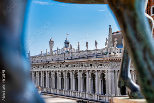 Ancient bronze horses of St Mark's Basilica over the St Mark's Square in Venice, Italy. Architecture detail of St Mark's Basilica in summer.