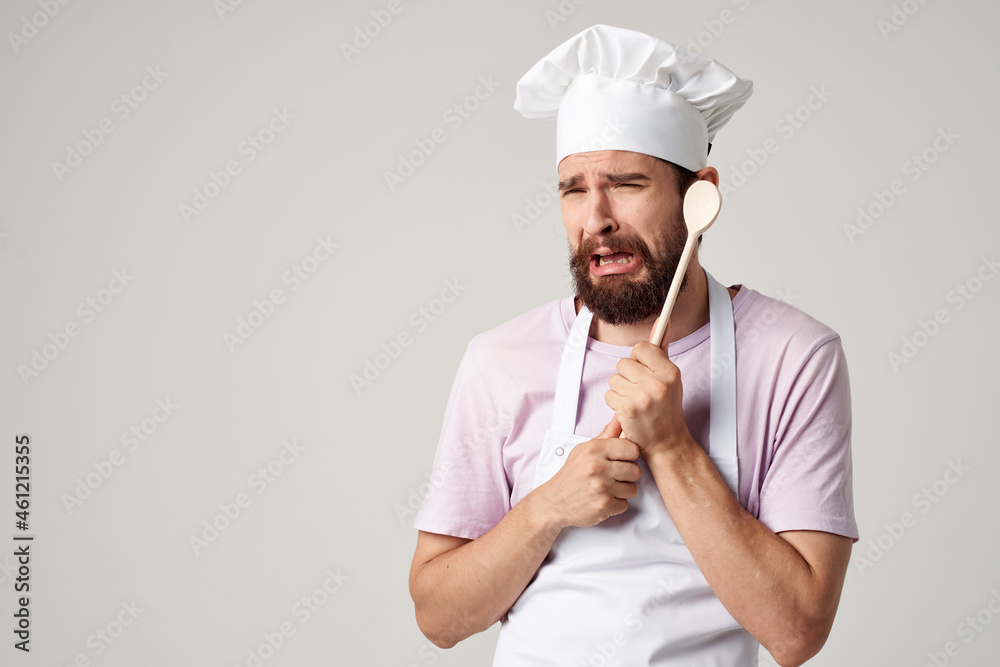 a man in a chef's uniform with a spoon in his hands cooking emotions a man in a chef's uniform with a spoon in his hands cooking emotions