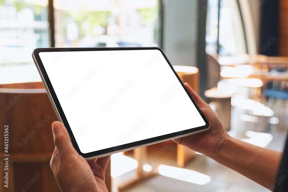 Mockup image of a woman holding digital tablet with blank white desktop screen