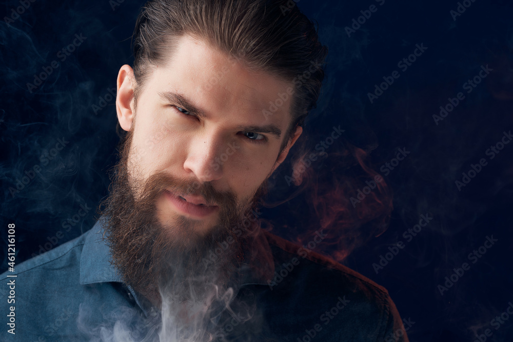 handsome man in a black shirt smoke clouds isolated background