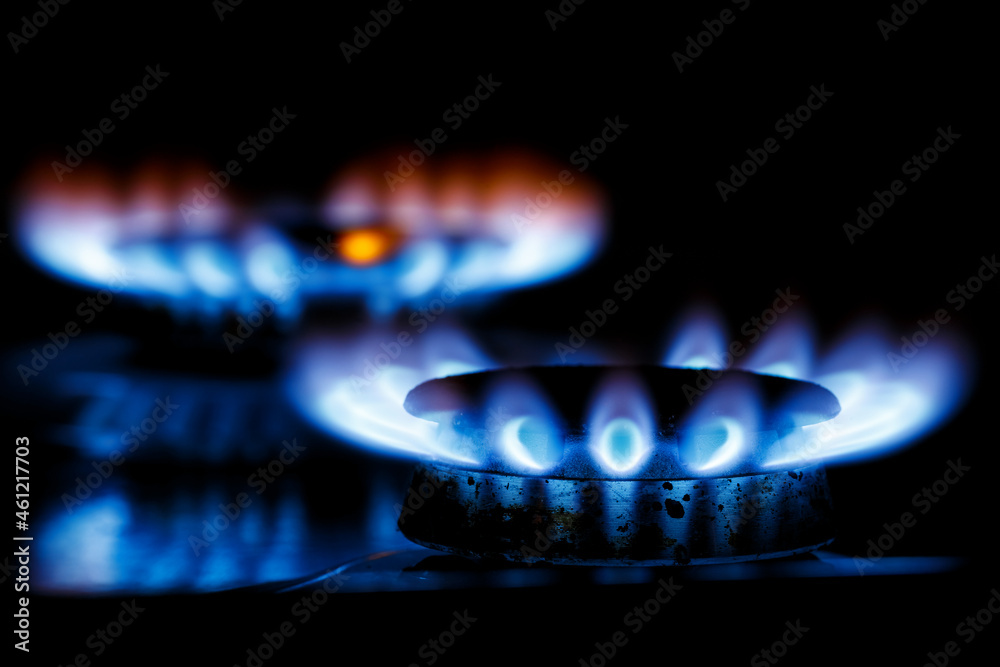 The blue flame of the two gas burner of the kitchen stove in the dark The blue flame of the two gas burner of the kitchen stove in the dark