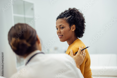Caring doctor reassuring female patient.