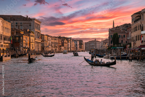 Amazing view on the beautiful Venice, Italy. Traditional gondolas sailing down the famous Grand canal at sunset.