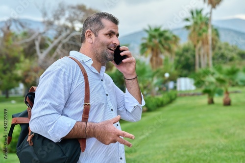 Mature business man talking on the phone outdoors