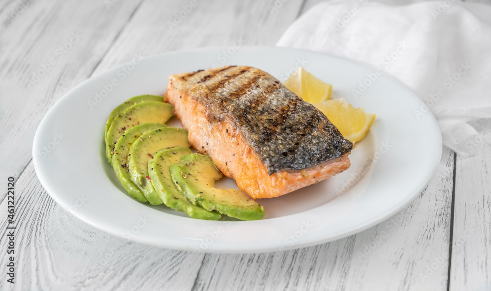 Fried salmon with avocado slices