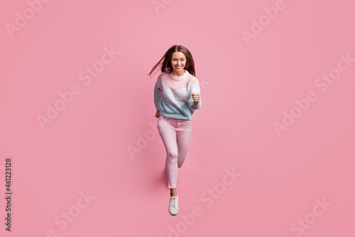 Full length body size photo of cheerful girl jumping running fast on sale smiling isolated on pastel pink color background