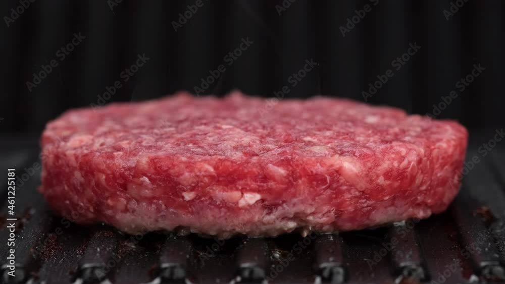 Grilling beef patty for burger close up. Making Tasty Hamburger. 4K UHD video Grilling beef patty for burger close up. Making Tasty Hamburger. 4K UHD video