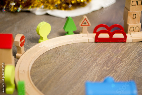 Railway with a toy train. Toys for a little boy and a girl. Wooden educational toys. A preschooler builds a railway at home or in a kindergarten, preschool.