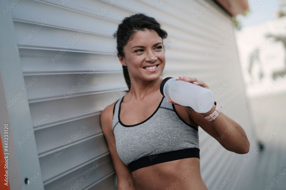 Beautiful athlete woman in sportswear. Young thristy woman training outdoors. Beautiful athlete woman in sportswear. Young thristy woman training outdoors.