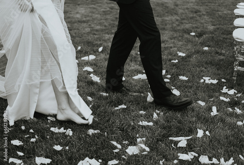 a fragment of legs walking on the grass. newlyweds