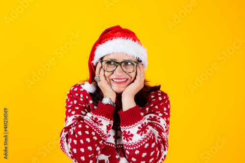 mature woman with santa claus hathappy with his hands resting on his face
