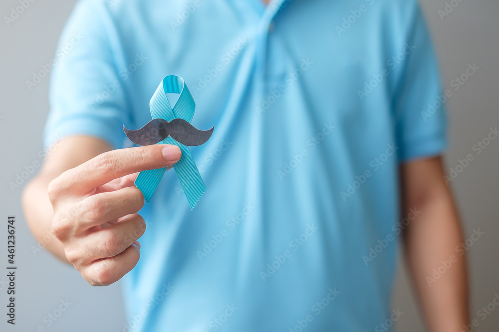 November Prostate Cancer Awareness month, Man holding Blue Ribbon with mustache for supporting people living and illness. Healthcare, International men, Father and World cancer day concept November Prostate Cancer Awareness month, Man holding Blue Ribbon with mustache for supporting people living and illness. Healthcare, International men, Father and World cancer day concept